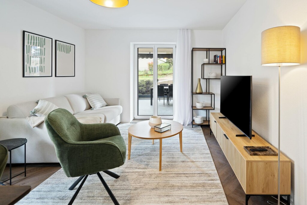 Living room with terrace access at STAYY Urban Base in Schlieren